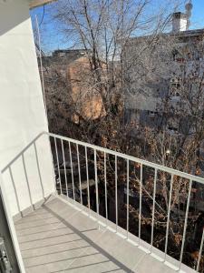 a balcony with a white railing on a building at Piso trabajo Rocafort 2 in Madrid