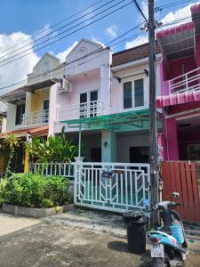a scooter parked in front of a house at Doze House Patong Phuket in Patong Beach