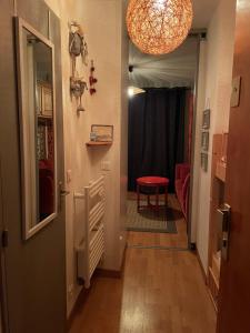 a hallway with a door and a room with a table at Studio cosy et sa terrasse in Beuil