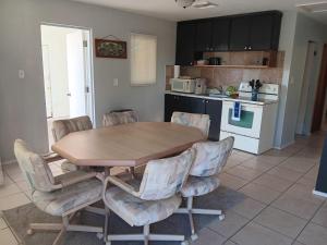 a kitchen with a wooden table and four chairs at GpL 3115 A Family Get Away in Fort Myers