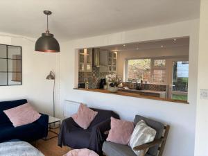 a living room with two couches and a kitchen at 2 Bed in Wareham oc-79228 in West Lulworth