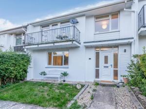 a white house with a balcony and a door at 2 Bed in Wareham oc-79228 in West Lulworth