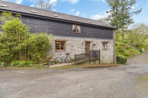 a stone house with a bike parked in front of it at 3 Bed in Knighton oc-b29329 in Felindre
