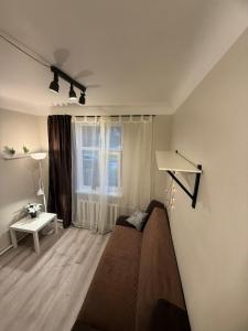 a living room with a couch and a window at Compact & Smart Mini Studio, self check-in in Rīga