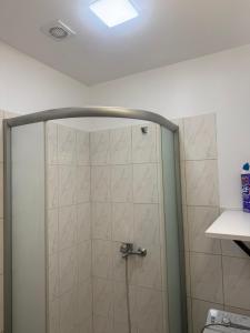 a shower with a glass door in a bathroom at Compact & Smart Mini Studio, self check-in in Rīga