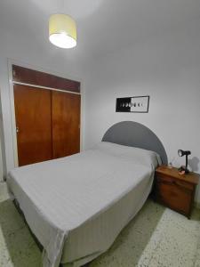 a bedroom with a bed and a wooden door at Nami in Necochea