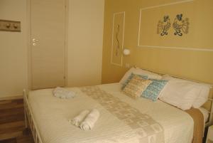 a bedroom with a bed with towels on it at Coro & Bentu in Alghero