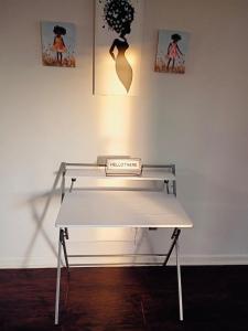 a white bench in a room with pictures on the wall at Fletcher Street Hideaway Room 8 with Cozy Vibes in Atlanta