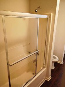 a shower stall in a bathroom with a toilet at Fletcher Street Hideaway Room 8 with Cozy Vibes in Atlanta