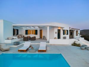 a villa with a swimming pool and a house at Villa Boa Milos 4 Bedrooms near Adamas in Adamantas