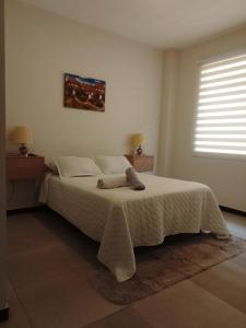 En eller flere senge i et værelse på Garzonier vacacional