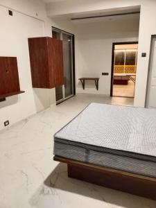 a bedroom with a bed in a room at Hare Krishna Beach Resort in Srīvardhan