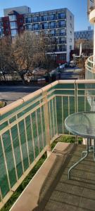 a balcony with a table and a fence at Relax Wellness Apartman in Pusztavacs