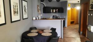 a dining room with a table and some chairs at Relax Wellness Apartman in Pusztavacs