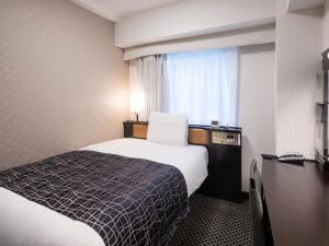Ένα ή περισσότερα κρεβάτια σε δωμάτιο στο APA Hotel Kanda Ekimae