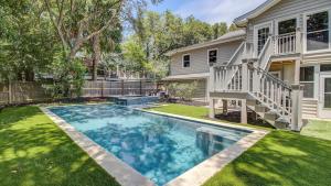 a swimming pool in the yard of a house at 11 43rd Avenue by AvantStay Pool Close to Beach in Isle of Palms