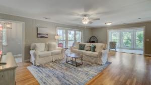 a living room with two chairs and a table at 11 43rd Avenue by AvantStay Pool Close to Beach in Isle of Palms