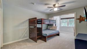 a bedroom with a bunk bed with a ceiling fan at 11 43rd Avenue by AvantStay Pool Close to Beach in Isle of Palms +43 photos