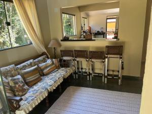 a living room with a couch and two chairs at Sítio com rio e muito verde! in Rio Bonito