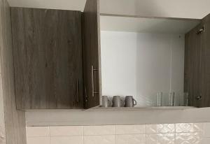 a kitchen with brown cabinets and a mirror at Vaal Home near Aquadome in Vanderbijlpark