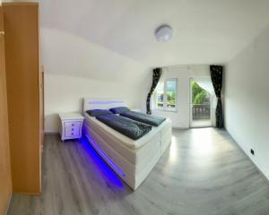 a bedroom with a bed with blue lights in it at Trojaner in Oberort