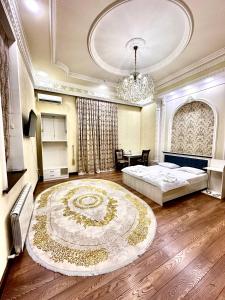 a bedroom with a bed and a chandelier at Cosmos Hotel in Yakkasaray