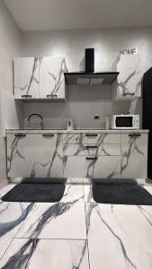 a kitchen with a marble counter top with a microwave at Naomi Luxury Home in Catania
