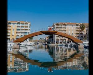 a bridge over a body of water with boats at T2 Port Frejus Grand Garage Prive in Fréjus