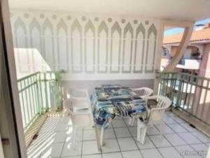 a room with a table and chairs on a balcony at T2 Port Frejus Grand Garage Prive in Fréjus +2 photos