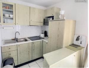 a dirty kitchen with a sink and a refrigerator at T2 Port Frejus Grand Garage Prive in Fréjus