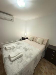 a bedroom with a large bed with towels on it at Cabaña in Vaqueros +23 photos