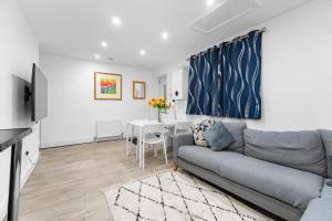 a living room with a couch and a table at 2 Bedroom house,BrownhillRd SE6 in London