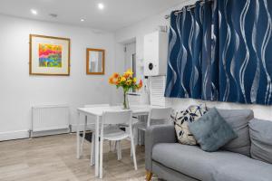 a living room with a couch and a table at 2 Bedroom house,BrownhillRd SE6 in London