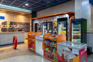 a store with a food counter and orange chairs at ibis budget RJ Praia de Botafogo in Rio de Janeiro
