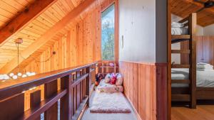 a wooden cabin with a bunk bed and a bedroom at 5BDR Hot Tub Deck Firepit Mins to Village Lake The Hilltop by AvantStay in North Shore