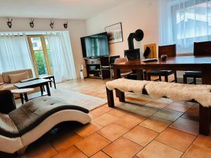 a living room with a table and a dining room at Apartment BERGfamilie - gemütlich ausgestattet, ruhig und familienfreundlich in Schliersee