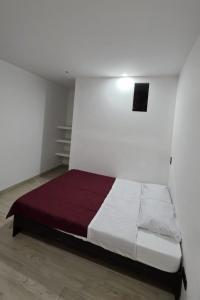 Giường trong phòng chung tại Hospedaje La Escondida