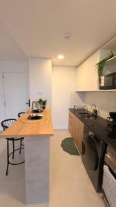 a kitchen with a counter and a table and a dishwasher at Refugio de lujo Piscina con Vistas panorámicas in Encarnación +22 photos
