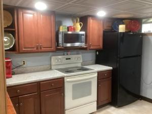 a kitchen with a white stove and a black refrigerator at Pet Friendly 2BR • King+Queen • Full Kitchen in Adamstown