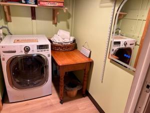 a laundry room with a washing machine and a table at Pet Friendly 2BR • King+Queen • Full Kitchen in Adamstown