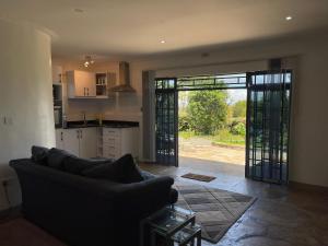 a living room with a couch and an open door at Homely Cottage Near Lake Naivasha, Elwai Visitor Centre in Heni Village +54 photos
