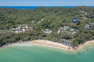 an aerial view of a beach with a stop sign at Noosa Escape 2BR Ocean Views, Walk to Beach in Noosa Heads