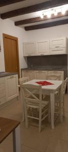 a kitchen with a white table and white chairs at Palazzetto Canossa in Venice +51 photos