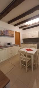 a kitchen with a white table and chairs at Palazzetto Canossa in Venice