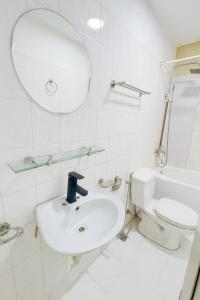 a bathroom with a sink and a toilet and a mirror at Four Seasons Serenity Studio - SDhousing branch in Hanoi
