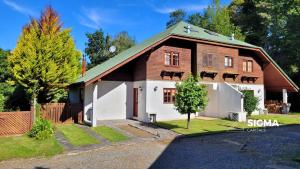 uma grande casa de madeira com uma garagem branca em Amplia Casa Familiar en Condominio Privado em Pucón
