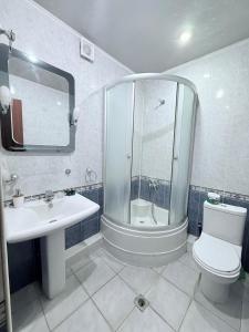 a bathroom with a shower and a toilet and a sink at 2 Bedroom 2 bathroom Republic Square in Yerevan