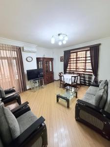 a living room with couches and a table and a piano at 2 Bedroom 2 bathroom Republic Square in Yerevan