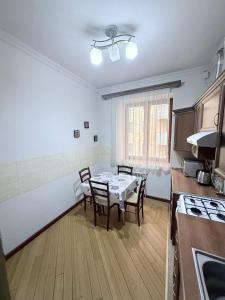 a kitchen with a table and chairs in a room at 2 Bedroom 2 bathroom Republic Square in Yerevan +6 photos