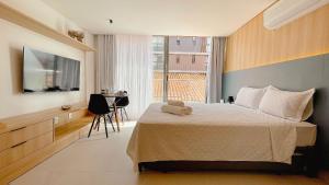 a bedroom with a bed with a teddy bear on it at Setai Aquamaris Luxo - By Almare in Tambaú +115 photos